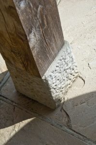 Detailed shot of a traditional staddle stone on wooden post
