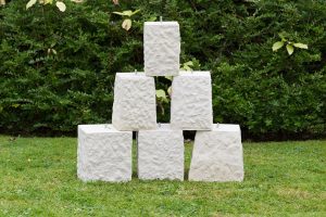 Staddle stones in a pile in the Chilstone show gardens