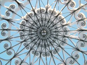 Wrought iron roof of a Chilstone garden pavillions looking magical covered in snow.