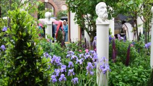 A Roman inspired garden with busts on pedestals and fluted columns.