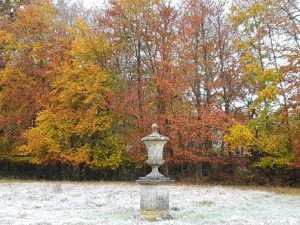 Chilstone's cast stone Northborne finial and pedestal makes a dramatic feature of the autumn trees.